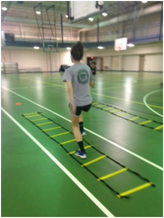Senior Megan Valenti leads the team in ladder drills in order to improve their quickness and agility. 