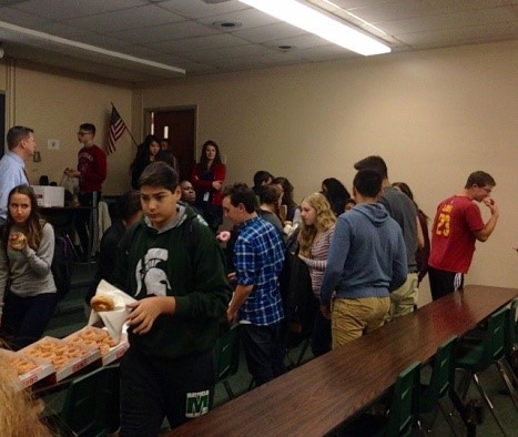 A Thursday morning Key Club meeting, with the club members eagerly receiving donuts.