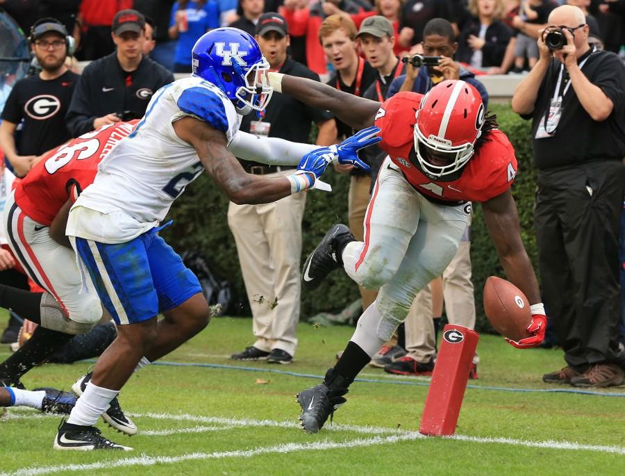 Georgia tailback Keith Marshall, right, just gets into the endzone past Kentucky defender Mike Edwards for a touchdown and a 24-3 lead during the third quarter on Saturday, Nov. 7, 2015, at Sanford Stadium in Athens, Ga. Georgia won, 27-3. (Curtis Compton/Atlanta Journal-Constitution/TNS)
