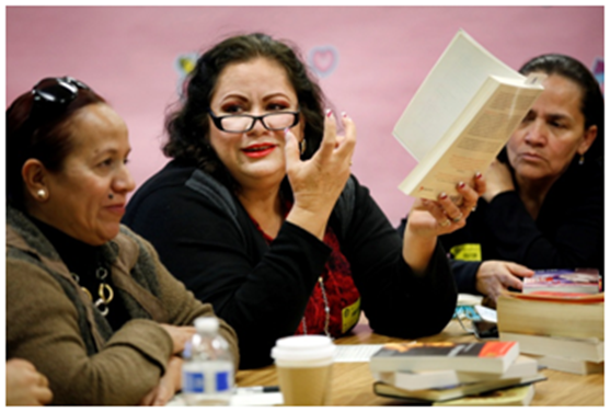 Nereyda R. Arenas, center, talks about a book she has read with other mothers at the Bravo Medical Magnet High School literature club on Monday, Feb. 22, 2016 