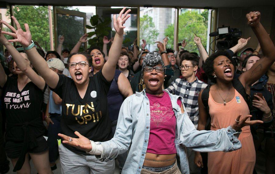 Krys Didtrey, left, and Gloria Merriweather, center, of Charlotte, N.C., lead chants in opposition to HB2 during a protest in the lobby of the State Legislative Building in Raleigh, N.C., on Monday, April 25, 2016.