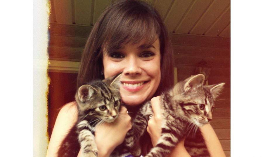 Kenzie Shay holds her two cats, both named after characters in The Great Gatsby.