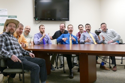 The Mustache for Cash participants include (from left to right): Bob Friel, Phil Deaton, Marty Mackar, Trevor McGrath, Bob Gynn, Ryan Pubentz, Mike Verdi, Michael Reinhard, and Brian Linn.  Not pictured: Nick Somich