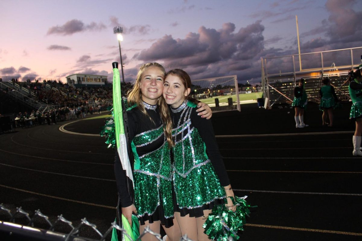 Sophomore Elise Holfeltz-a flag- and  sophomore Jenna Loprich - a catette (left to right).