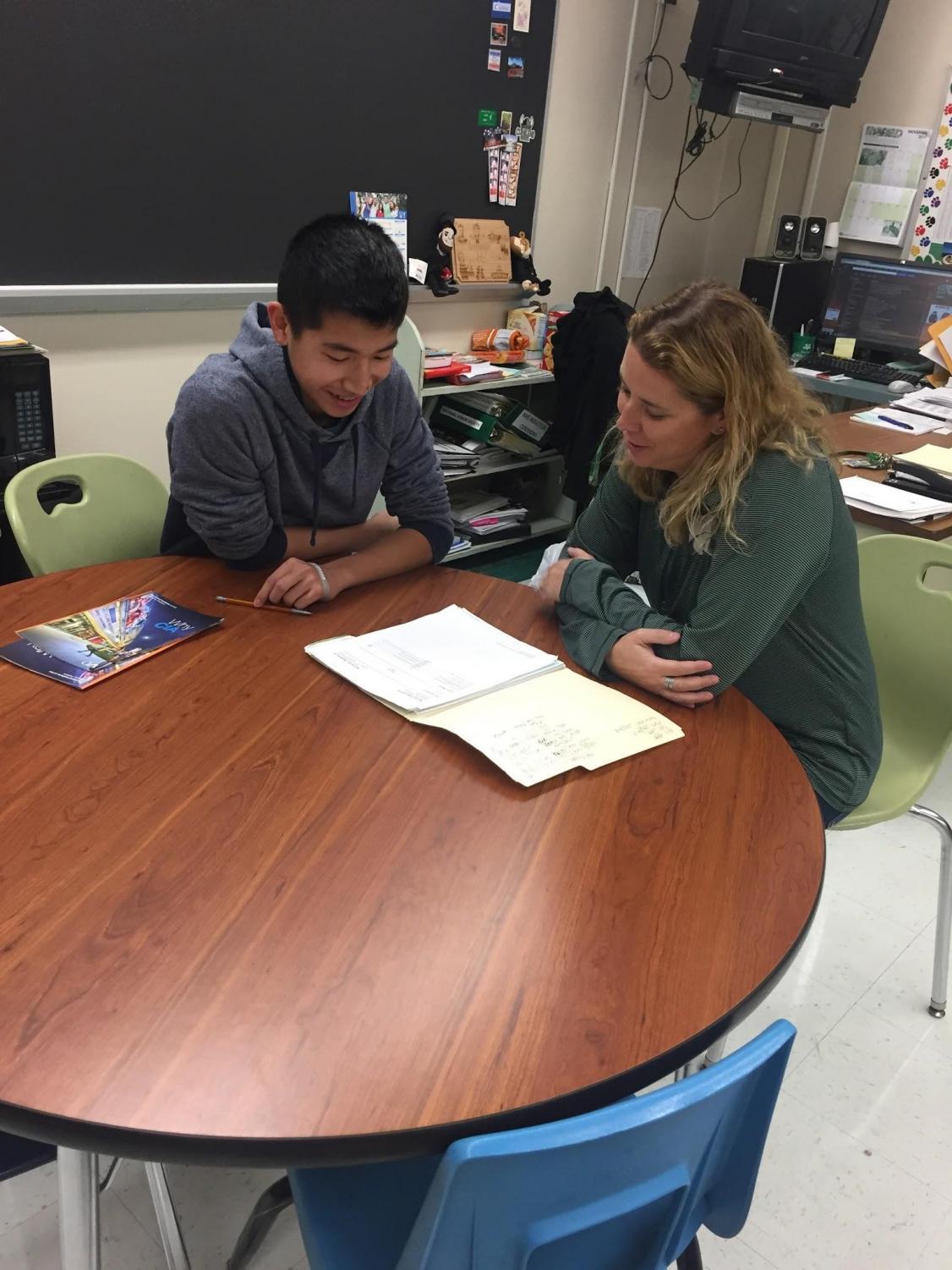 If homeroom is eliminated, students may have advisory time to work on-on-one with staff members. Pictured: Trenton Lam and AEP teacher Jen Hyland.