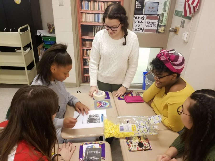Mollie Davis leads a group of students in a small project at the most recent Women’s Studies Club showing the important role of positive media. 