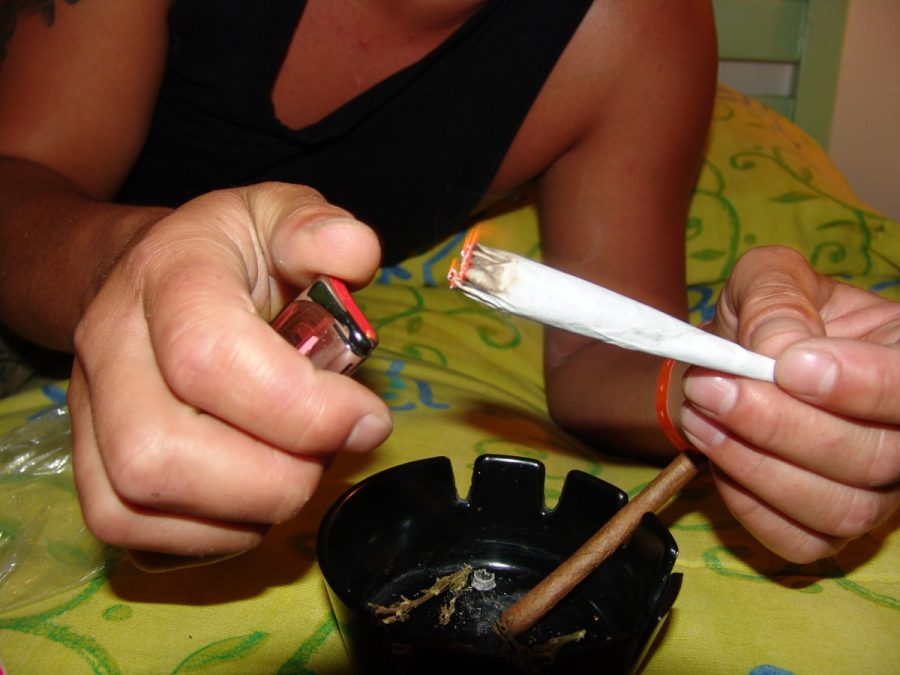 A person prepares to light a blunt. Photo from PXHere.com