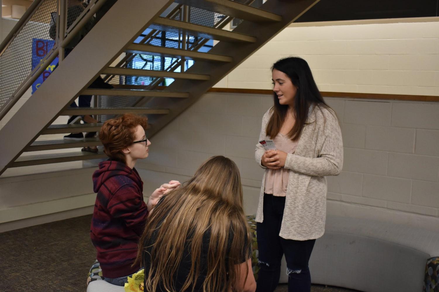 Senior class officer Bailey Ross chats with new students at the annual student breakfast.