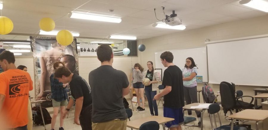 Improv Club prepares to play Loser Ball at its first club meeting of the year.  Standing in the center, holding the ball, is English teacher and club adviser Alex Shaw.