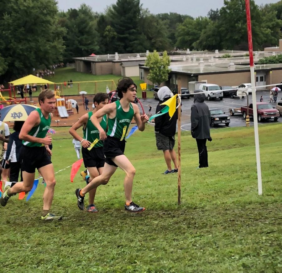 Juniors Ignacio Veloz and Henry Suster, and senior Hayden Palmer fighting to get up the hill at the Brecksville Invitational.