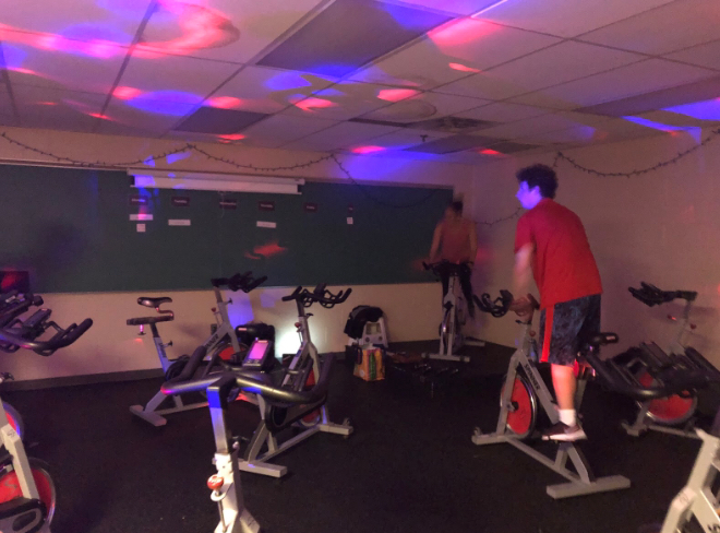 Instructor Abigail Ferritto engages the class with bright lights and intense music.
Ferritto is on the left and Cody Piunno is on the right
