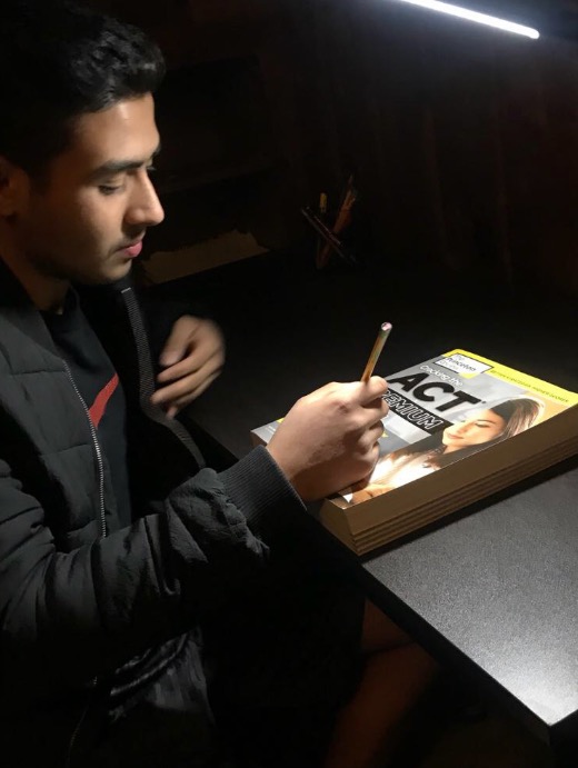 Prabesh Adhikari uses his Princeton Review book as a guide while practicing for the ACT.