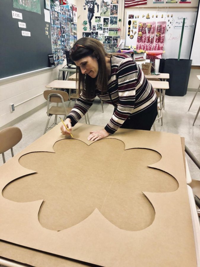 Cats Cabinet adviser Chris Czikray cuts out decorations for Saturdays dance.