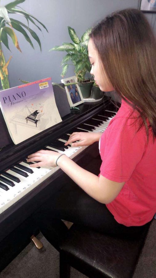 Mackenzie Michaud practices playing piano for the Talent Show.