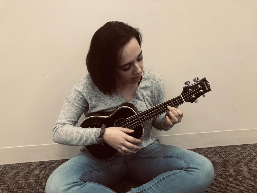 Junior Angelina Beukemann practices her ukulele in the Senior Commons.  She’ll be performing at Open Mic Night on Friday.