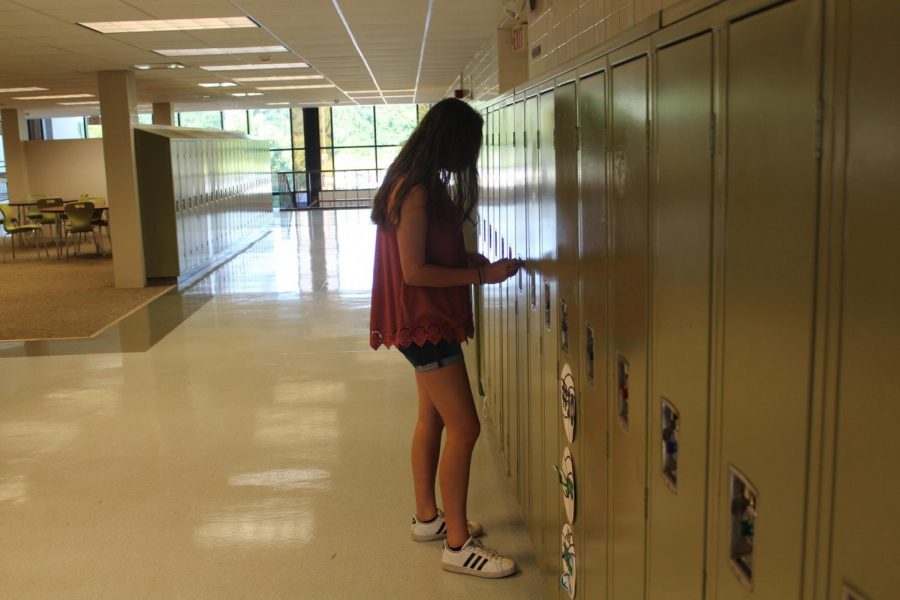 A freshman visits her locker instead of being in class.