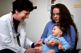 A baby receives a vaccination shot from a doctor.
