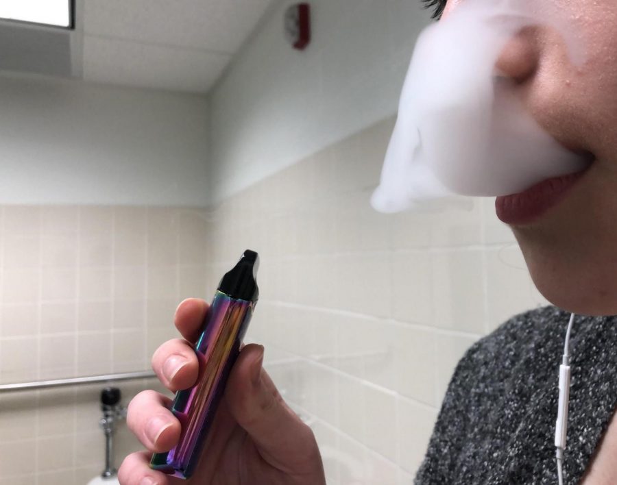 A student vapes in the bathroom at Mayfield High School.
