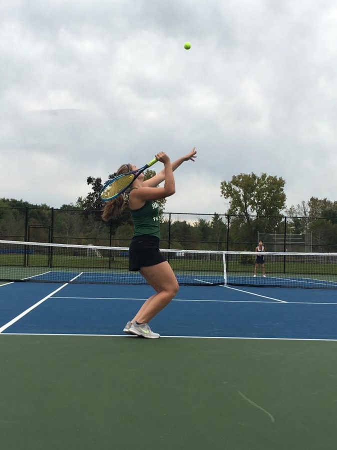 Varsity+tennis+player+Katie+Eippert+is+seen+serving+at+Highland+Heights+tennis+courts.+