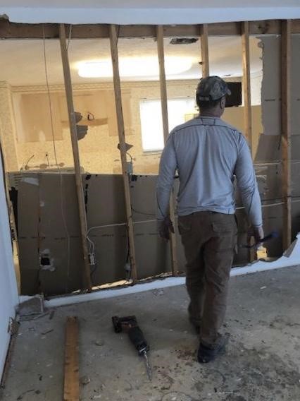 Ferritto’s father-in law helps tear down the walls in the new house in preparation for renovation. 