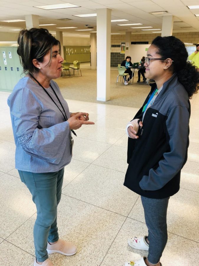 Hall monitor Rosalba Antonelli speaks with a wandering student by the Math Commons.