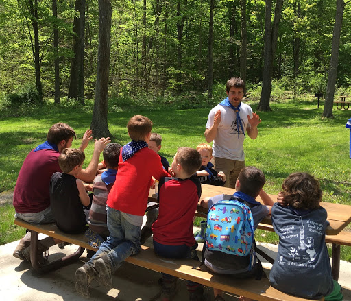 Matthew Szigeti (standing in white) singing with the Cub Scouts at a scout outing on Saturday May 11, 2019. 