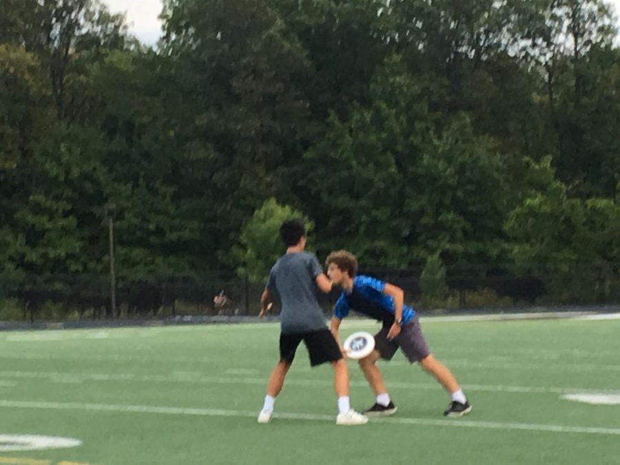 Member Yukun Wang blocks junior Paul Zito from throwing the frisbee to the opposing team.