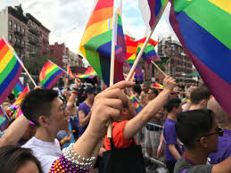 People gather in New York City waving pride flags and celebrating the LGBTQ+ community going against the ideas of conversion therapy. 
