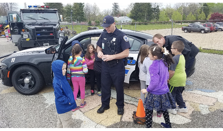 Officer Stuart spreads his kindness by visiting with and helping children across the district.
