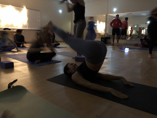 Junior Valerie Sague works on her hand stand before yoga class begins. 