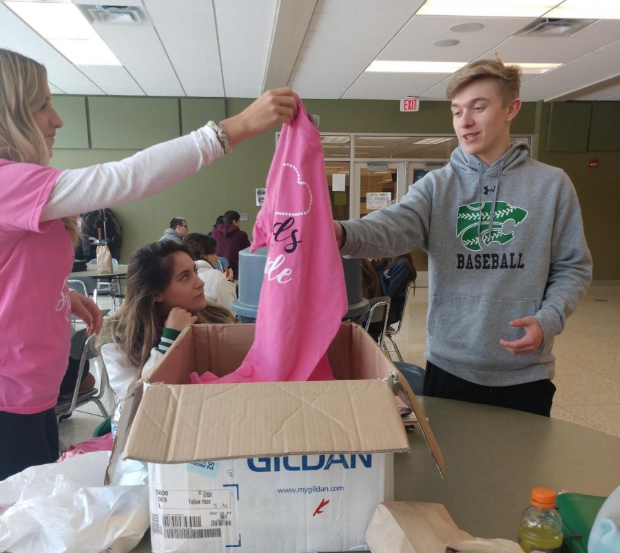 Junior Matthew Osler buys a $10 St. Jude t-shirt today during 5th period lunch.