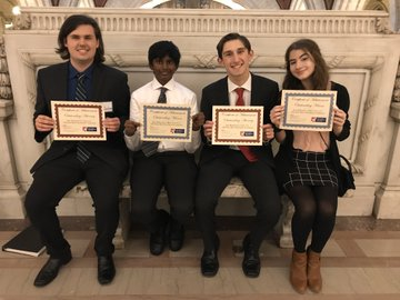 After winning multiple team and individual awards at both their trials, Nick Korzhiletsky, Abhi Siri, Johnny Gaudio, and Emily Kolominsky celebrate inside the courthouse with their awards.