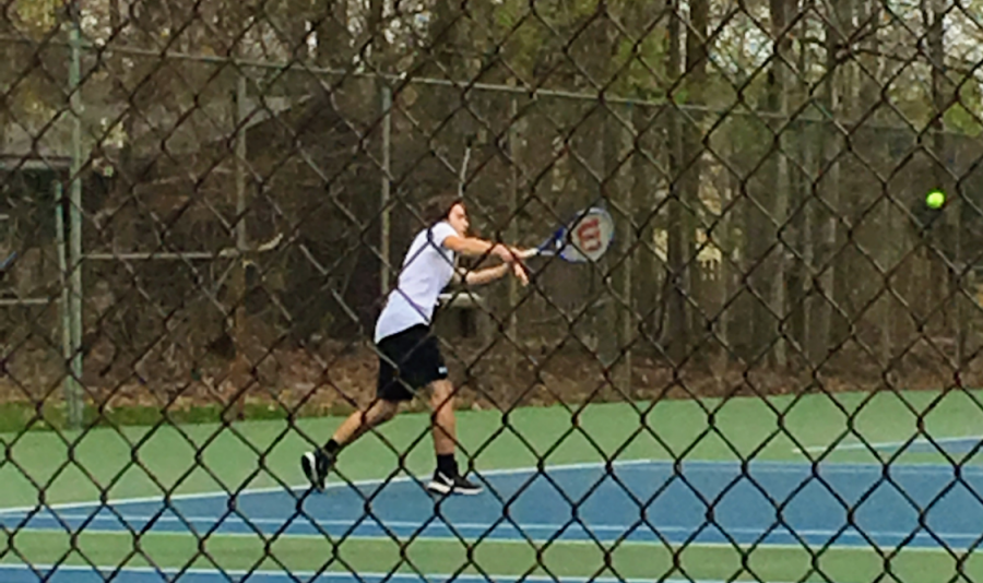 Senior Ben Kloppman volleys with his opponent during a match last season.