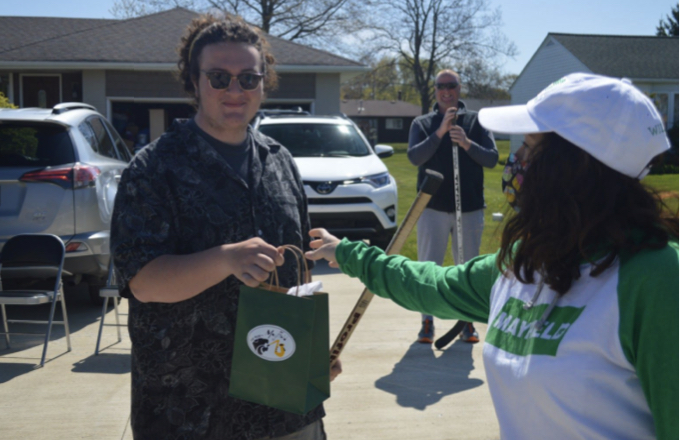 President to President: Band booster president Stephanie Bluffestone delivers a graduation gift to band president Jack Giessy at last weeks parade.