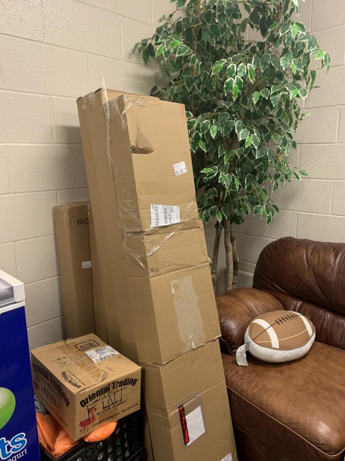 Unopened boxed of homecoming decorations fill the student council office.