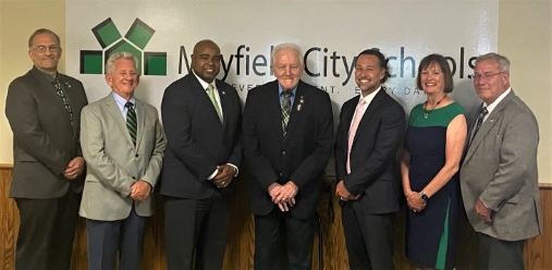 Dr. Michael Barnes, third from the left, stands with Treasurer Scott Snyder and members of the school board.  Dr. Barnes said hes focused on creating more opportunities for Mayfield students.   I think the more that we can look to expand opportunities for kids, the better the outcomes for them and their futures, he said.