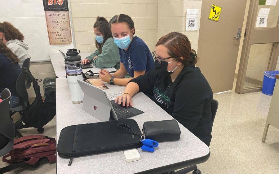 All Masked Up: Seniors Sarah Carlile, Megan Linsky, and Gia Berardinelli work in Mr. Somichs G1 class.