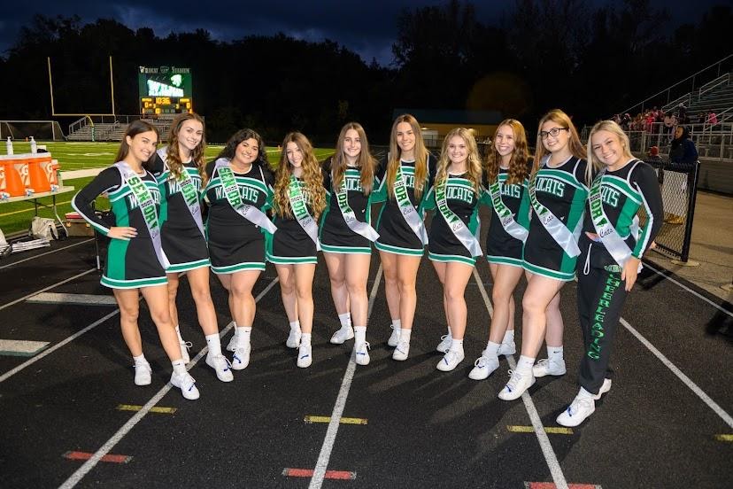 The senior cheerleaders huddle together before the start of the senior night game against Kenston.