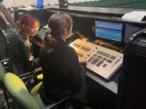 Seniors Kingsley Jones and Kelsey Blanchard look over the soundboard as they wait for the shows rehearsal to begin.
