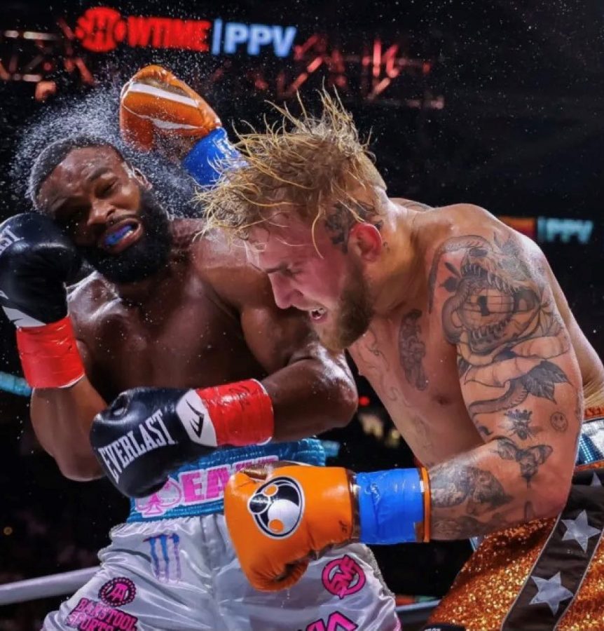 Jake Paul fights Tyron Woodley in late August. Spanish teacher Jerry Turk has followed Pauls path into boxing and has been impressed.  He said, Boxing was huge when I was a kid, and Jake brings the younger generation and YouTubers to watch it.”