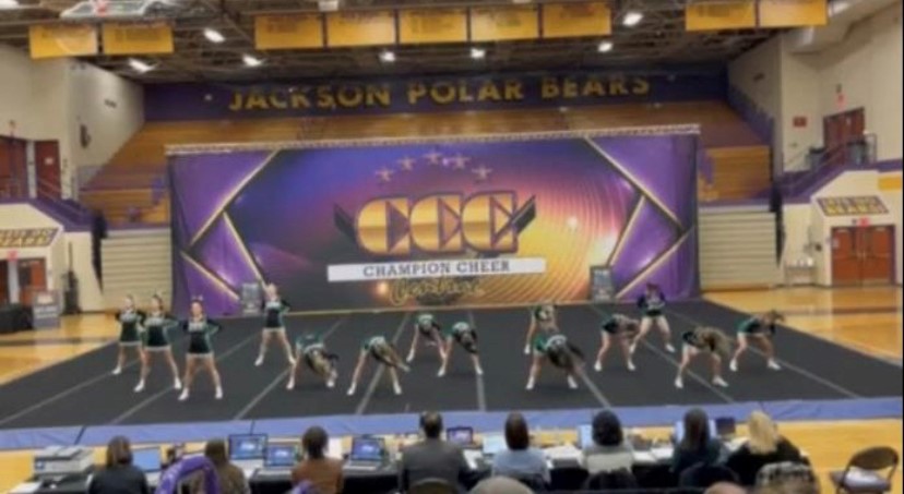 The varsity cheerleaders perform one of their complex cheers at the Massillon Jackson competition.  Junior Grace Sherlock was glad the team competed in the tournament. She said, It helped us to bond more as a team and increase confidence in ourselves.”