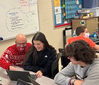 Math teacher Marty Mackar confers with sophomore Arianna Brunello during their G2 class.  The 90-minute block schedule allows for more opportunities for students to meet with their teachers, but some students struggle to sit through classes of that length.  Assistant principal Jarrod Mulheman doesnt know what schedule will be used next year but said, I know that the majority of staff favor the block.