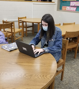 Junior Mary Jo Baetzold, who received an Honorable Mention award for her humor piece, works diligently on her laptop, writing her next story.