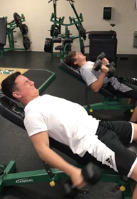 Nick Sipos and Dwight Fritz, Jr. lift in the weight room during the off-season.