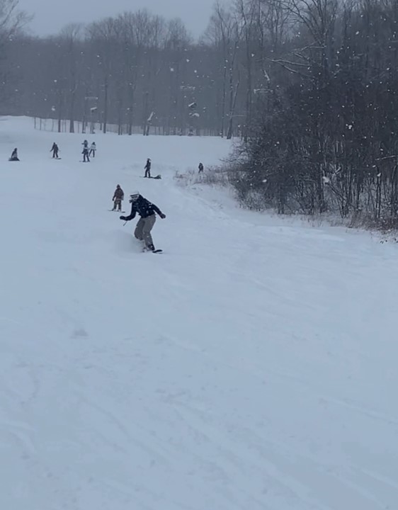 On a snowy January day,  sophomore Elenore Bausone snowboards at Alpine Valley. She said, My goals in the future are to definitely improve. I want to be able to go down any hill that I try, both at Brandywine and at Alpine.