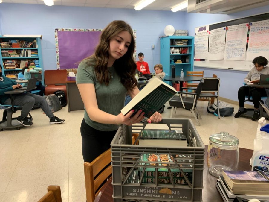 Freshman Nora Klein looks at a new copy of 