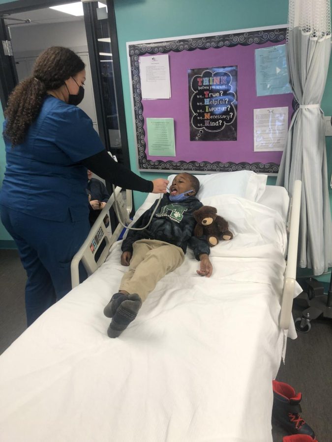Medical Technologies senior Nyah Rogers completes a patient check-up with a Millridge kindergartener.  Med Tech and all Excel TECC programs will be inheriting new students next year.
