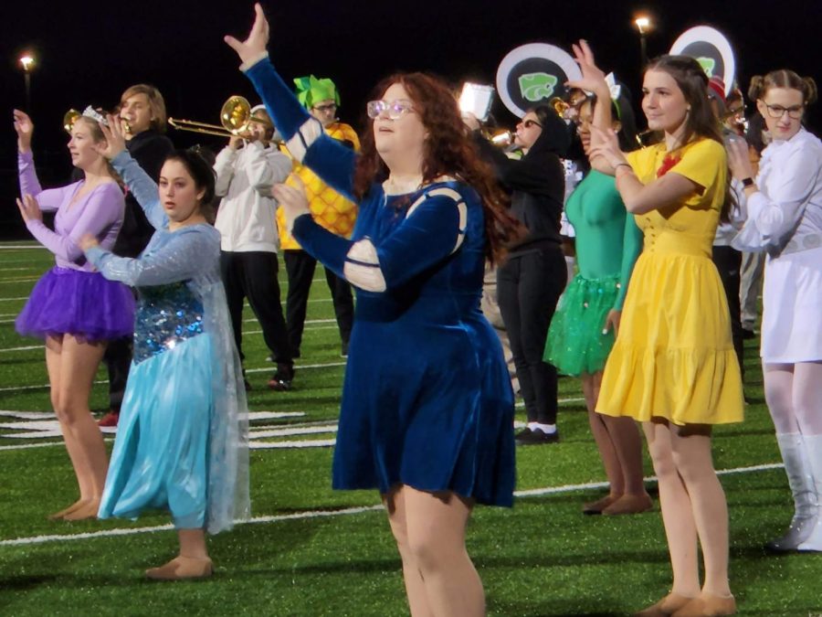 Dressed in a variety of Halloween costumes, members of the Auxiliary and Band perform at last Fridays Halloween halftime show.