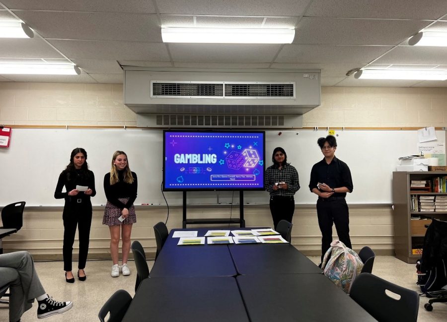 Gianna Condelli, Anna Rini, Vishista Nayak, and Henry Tran present a speech during their AP Seminar class.