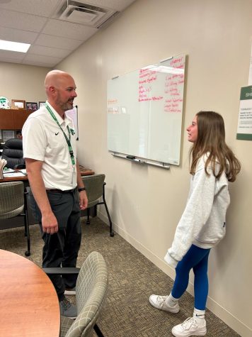Principal Jeff Legan talks with sophomore Taylor Arth about her summer plans.  